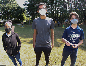 Three Georgia Tech students with their rocket 