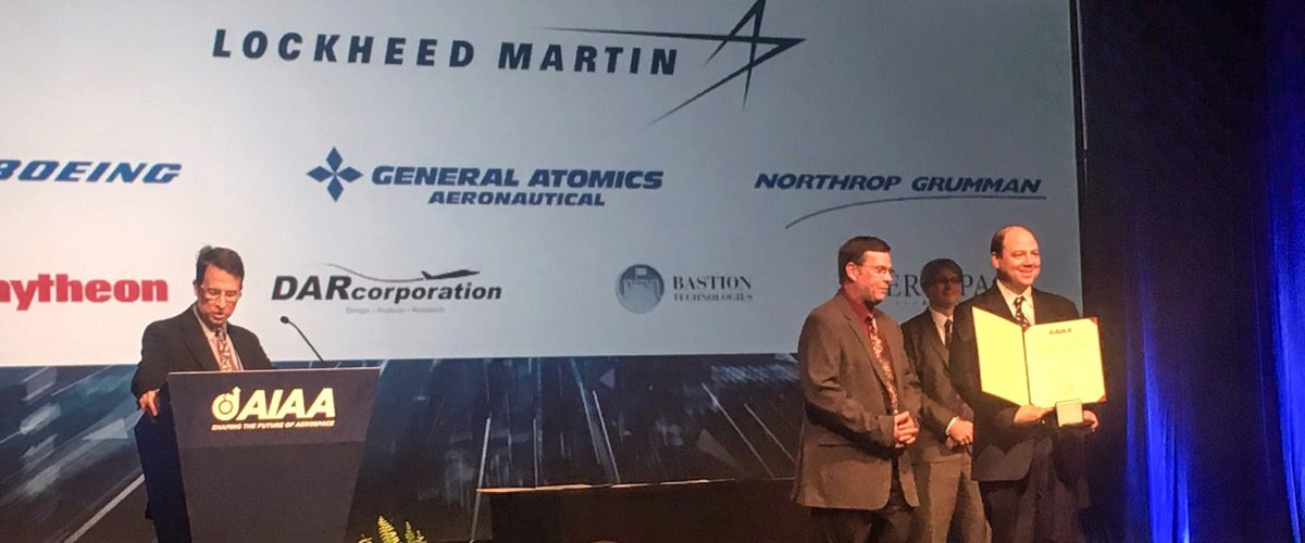 E Glenn Lightsey on stage at Sci Tech receiving the Award