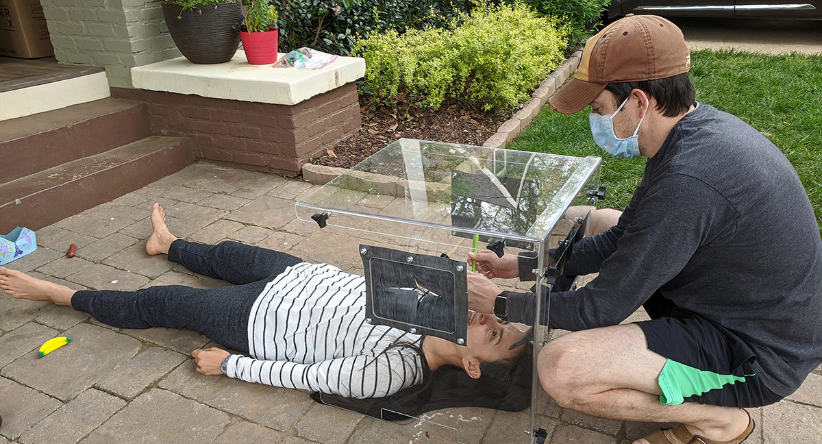 Emory University Dr. Jay Sanford testing out the final prototype of the intubation cover that ABC organizer Lee Whitcher helped to design