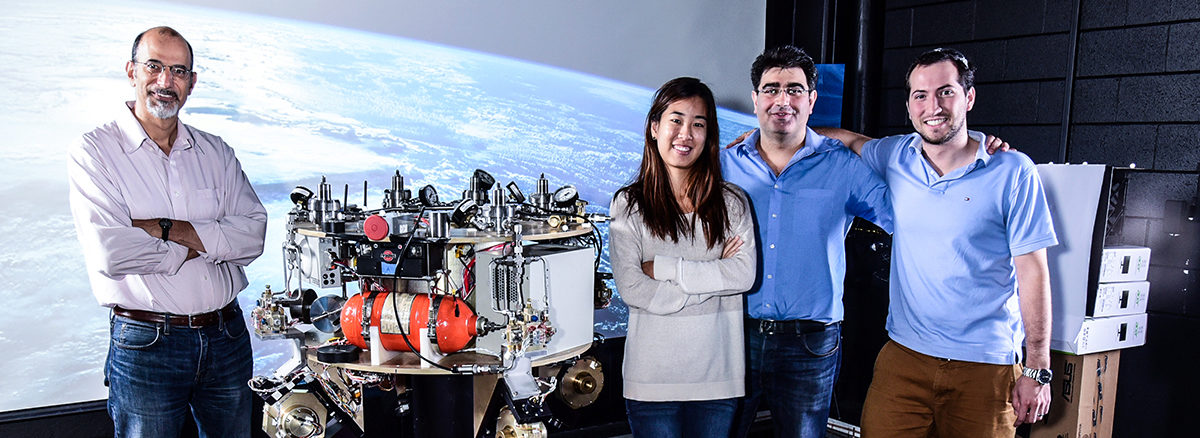 Prof. Tsiotras with threee of his graduate students in his lab