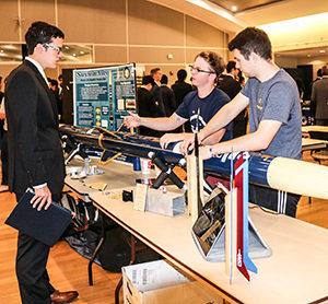 Carson Coursey and Casey Wilson talk to a classmate about their award-winning rocket project, Sustain Alive.