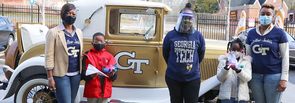 Photo of TAG students and staff with the Ramblin' Wreck