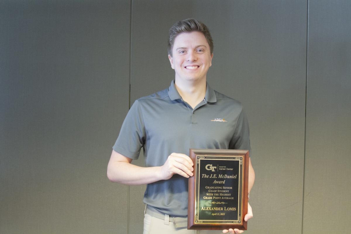 Alexander Lomis holds his J.E. McDaniel Award plaque during the Career Center's Award Ceremony, Spring 2023