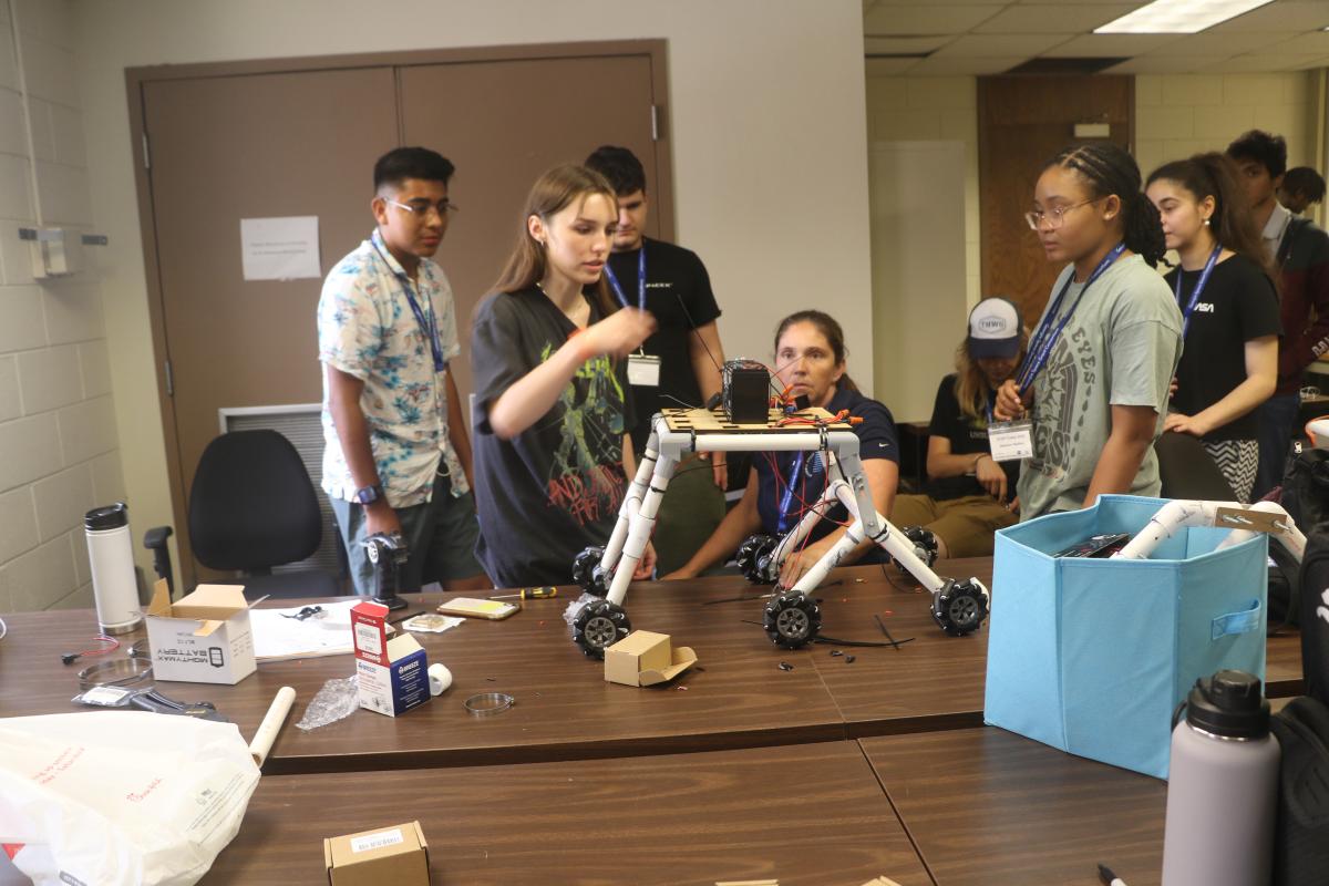 Prof Griendling working with students on a rover